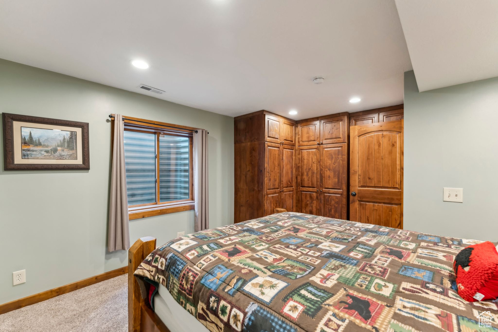 Bedroom featuring light carpet, recessed lighting, and baseboards