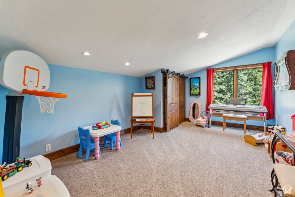 Rec room with carpet flooring, vaulted ceiling, baseboards, recessed lighting, and a textured ceiling