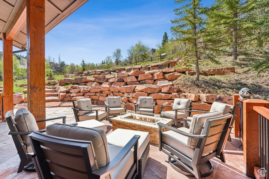 View of patio featuring an outdoor fire pit