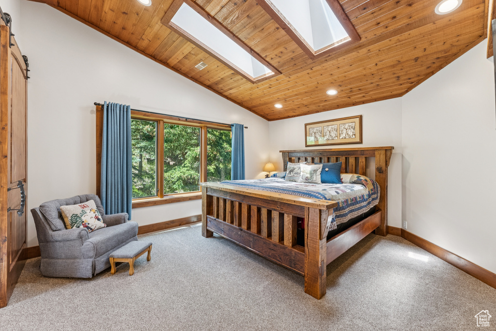 Bedroom featuring carpet, a skylight, recessed lighting, vaulted ceiling, and wood ceiling