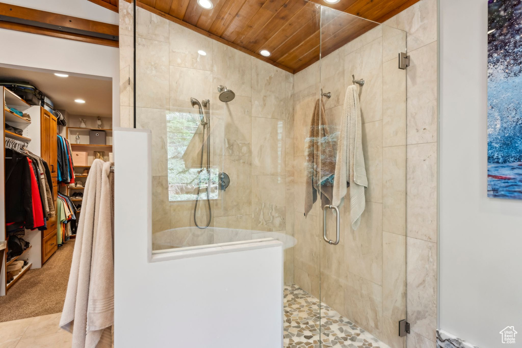 Bathroom with a stall shower, recessed lighting, a walk in closet, and wooden ceiling