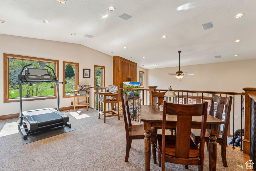 Dining space with lofted ceiling, recessed lighting, light colored carpet, baseboards, and a ceiling fan
