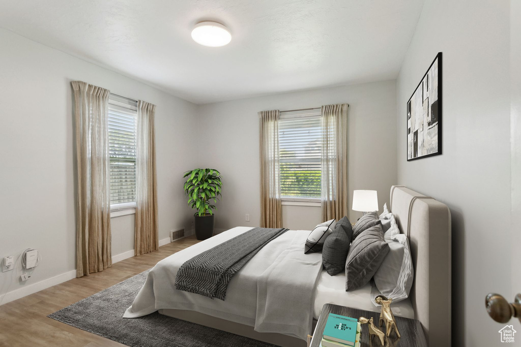 Bedroom featuring wood finished floors and baseboards