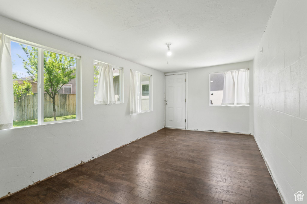 Spare room with plenty of natural light and hardwood / wood-style flooring