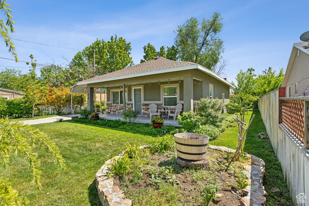 Rear view of property with stucco siding and roof with shingles