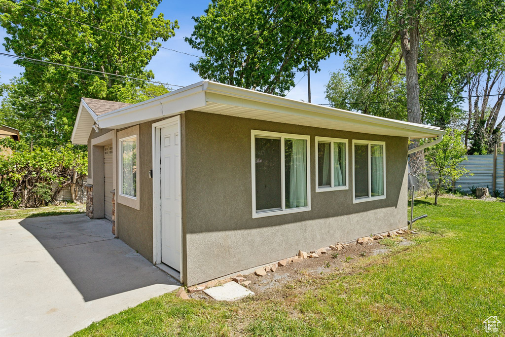 View of home's exterior with stucco siding and a patio area