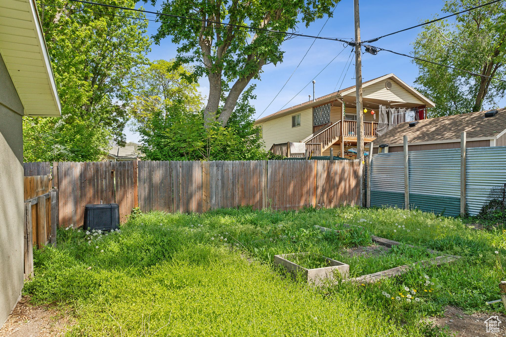 Fenced backyard featuring a garden
