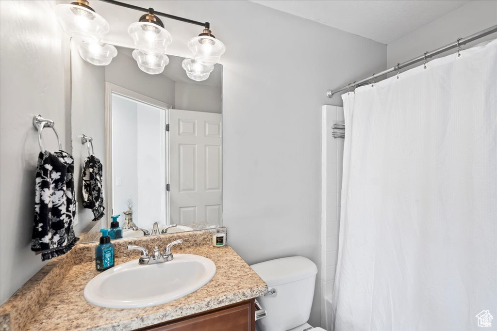 Full bathroom with vanity and toilet