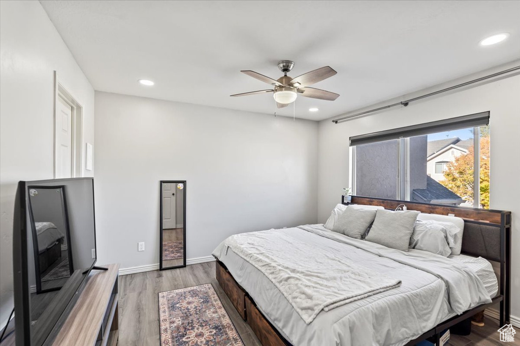 Bedroom with wood finished floors, recessed lighting, baseboards, and ceiling fan