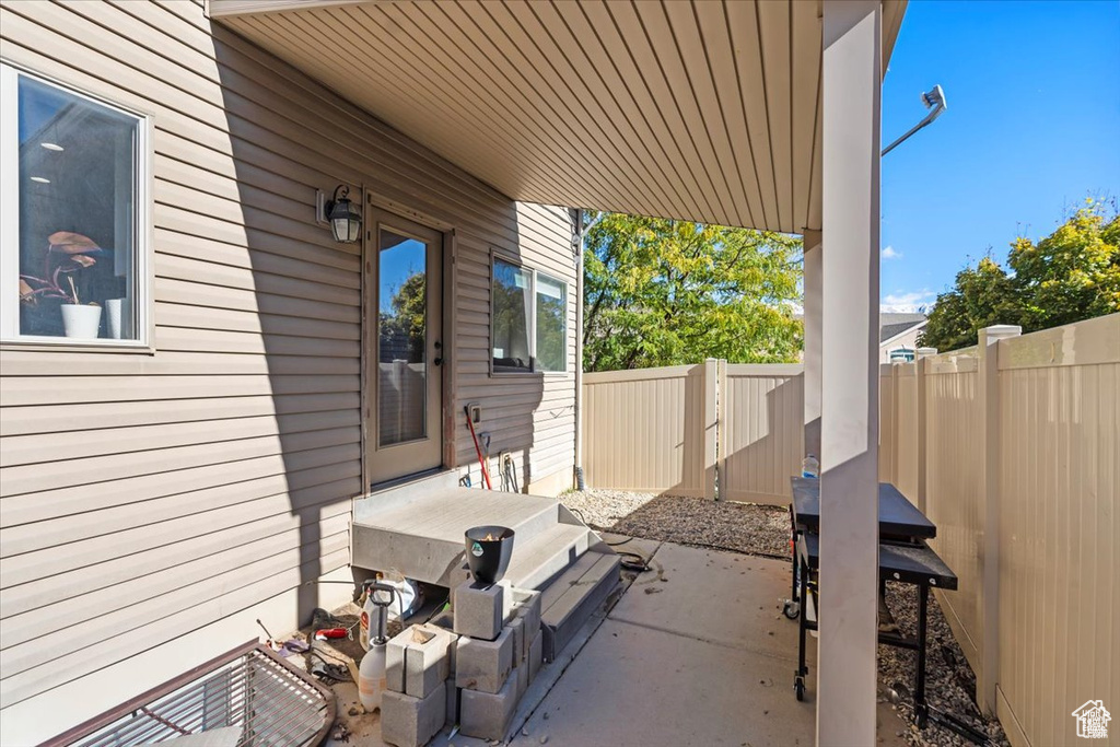 View of patio featuring fence