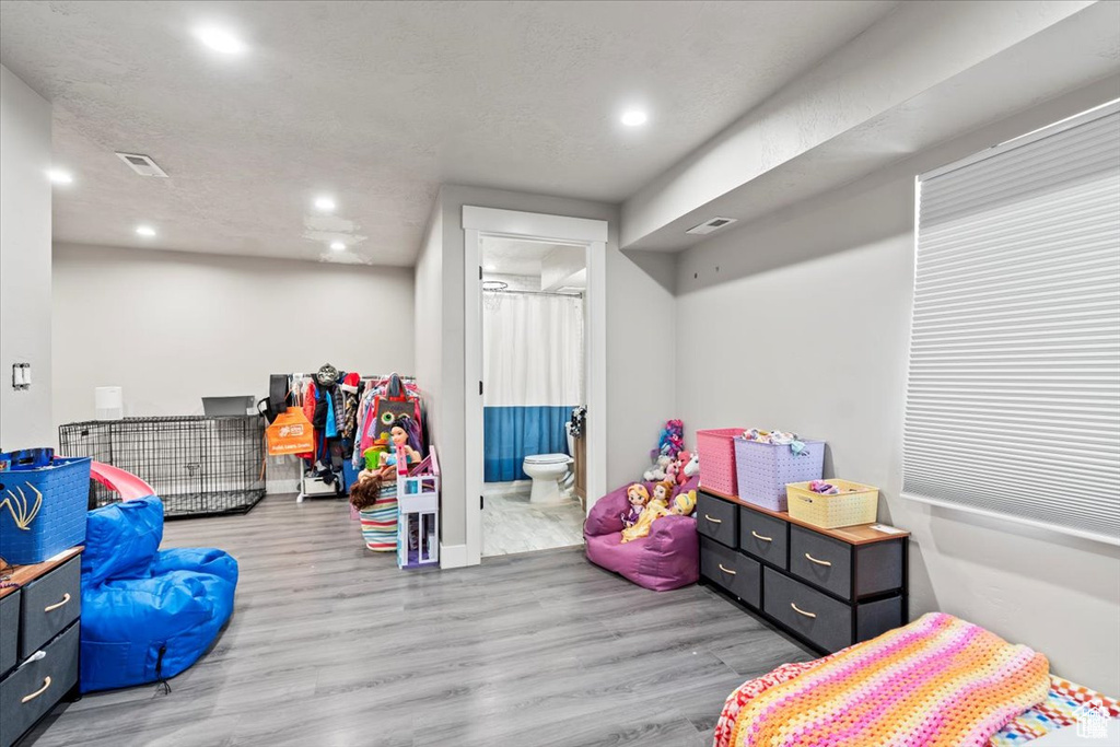 Playroom featuring wood finished floors, recessed lighting, and baseboards