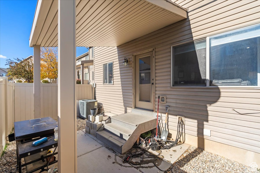 View of patio / terrace featuring fence and cooling unit