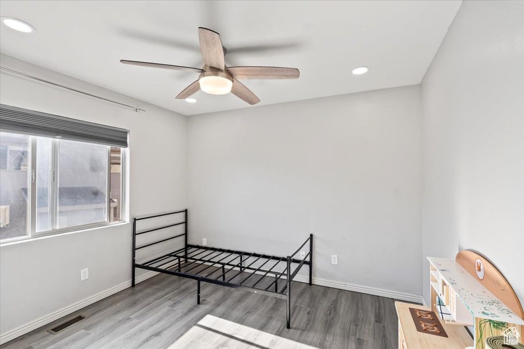 Unfurnished bedroom featuring wood finished floors, recessed lighting, baseboards, and ceiling fan