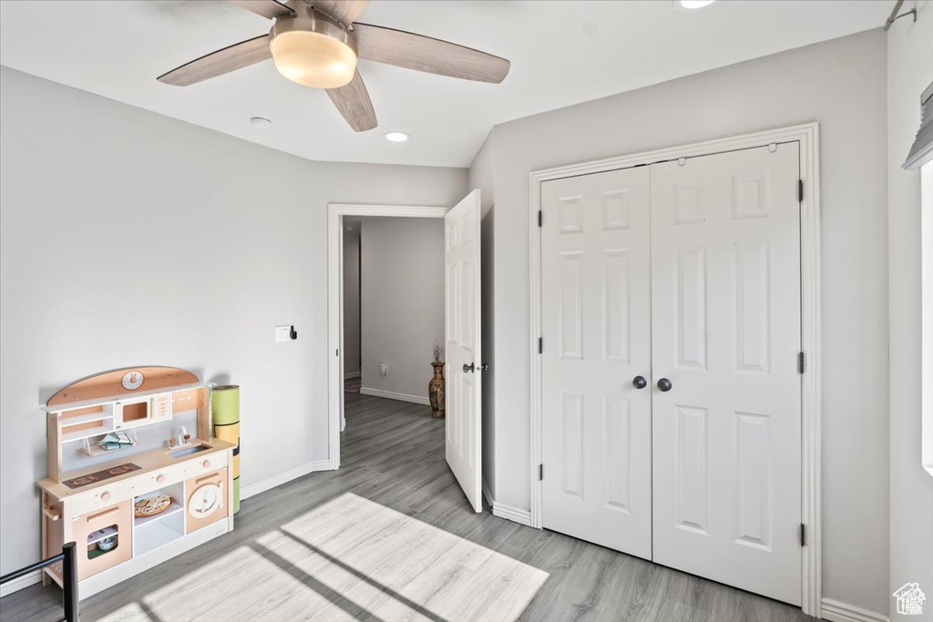 Unfurnished bedroom with wood finished floors, recessed lighting, a closet, baseboards, and a ceiling fan