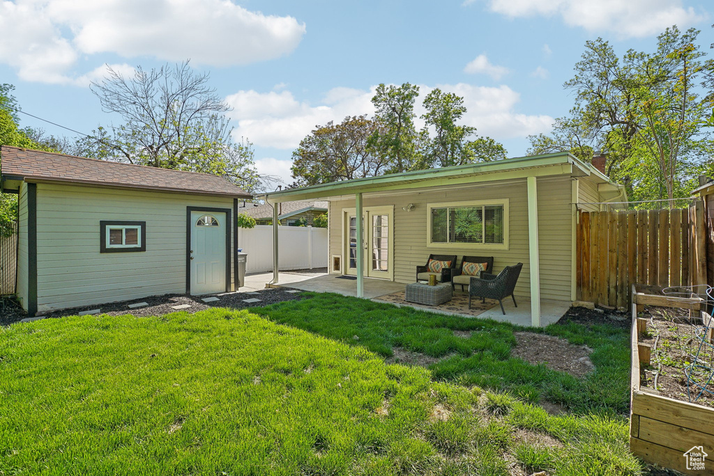 Back of house with a patio area, an outdoor structure, and outdoor lounge area