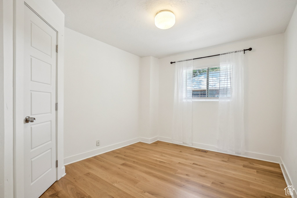 Unfurnished room featuring light wood-style flooring and baseboards