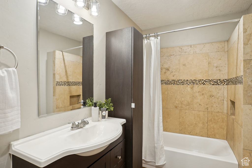Full bath featuring shower / bathtub combination with curtain and vanity
