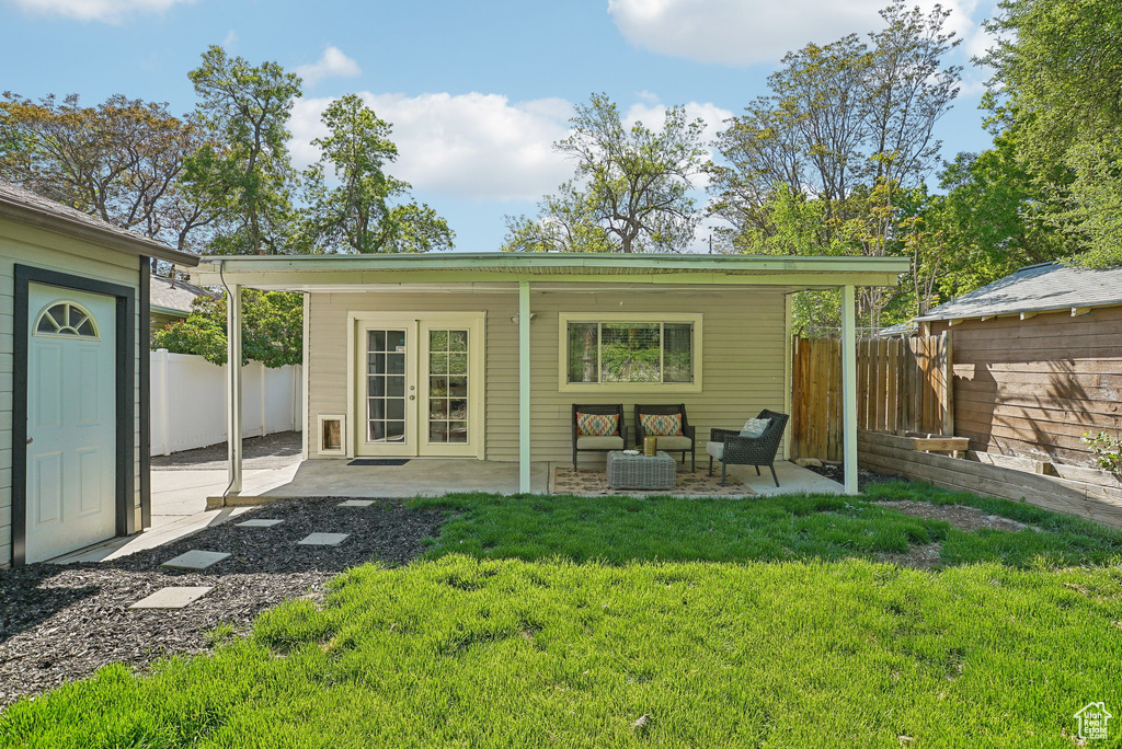 Rear view of house with an outdoor living space and a patio area