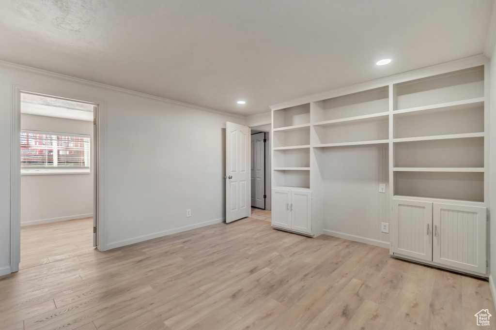Unfurnished bedroom featuring baseboards, crown molding, light wood-type flooring, and recessed lighting