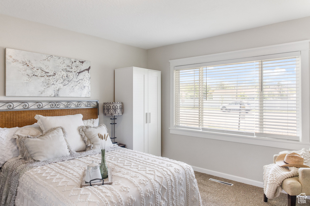 Carpeted bedroom with baseboards