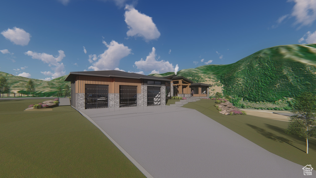 View of front of house featuring stone siding, a mountain view, driveway, and an attached garage