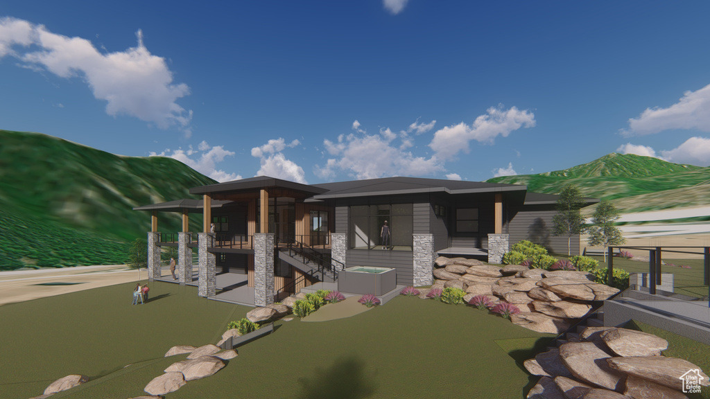 Rear view of property with stone siding and a mountain view