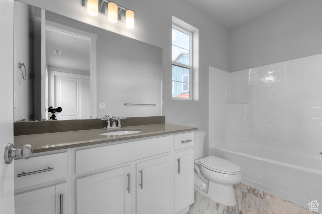 Bathroom with toilet, vanity, shower / washtub combination, and marble finish floors