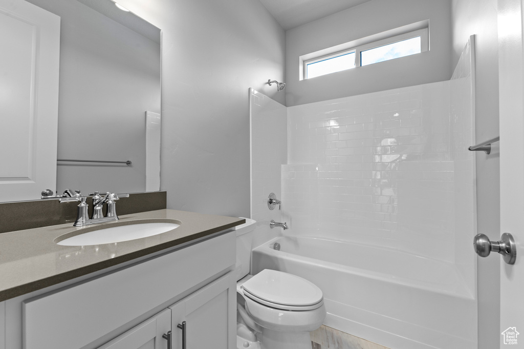 Full bath featuring toilet, bathtub / shower combination, and vanity