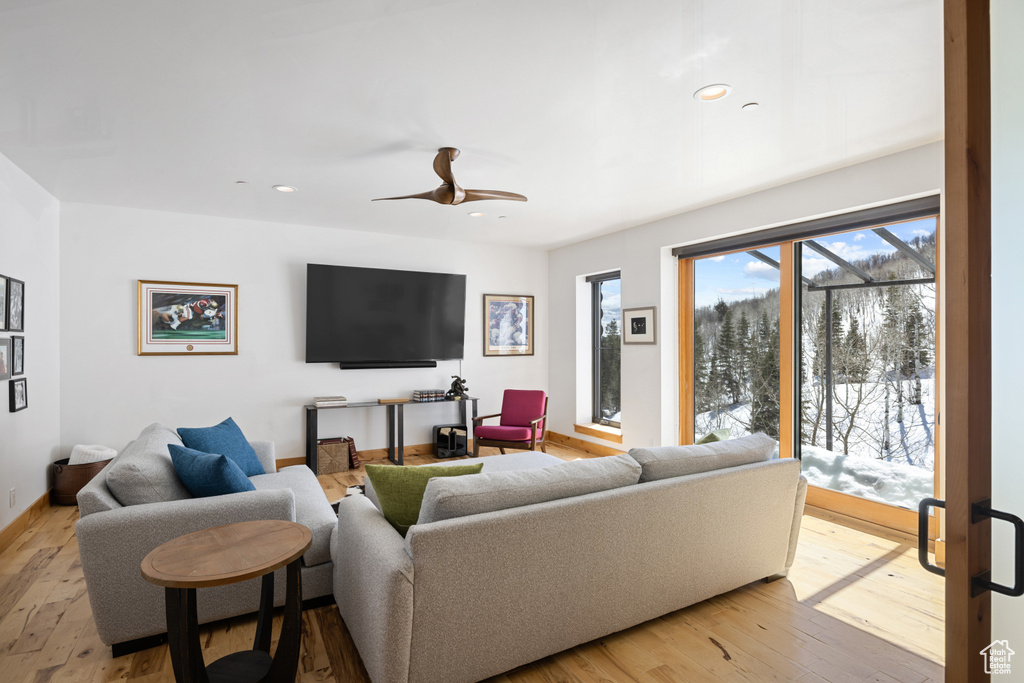 Living room featuring wood-type flooring, recessed lighting, and ceiling fan