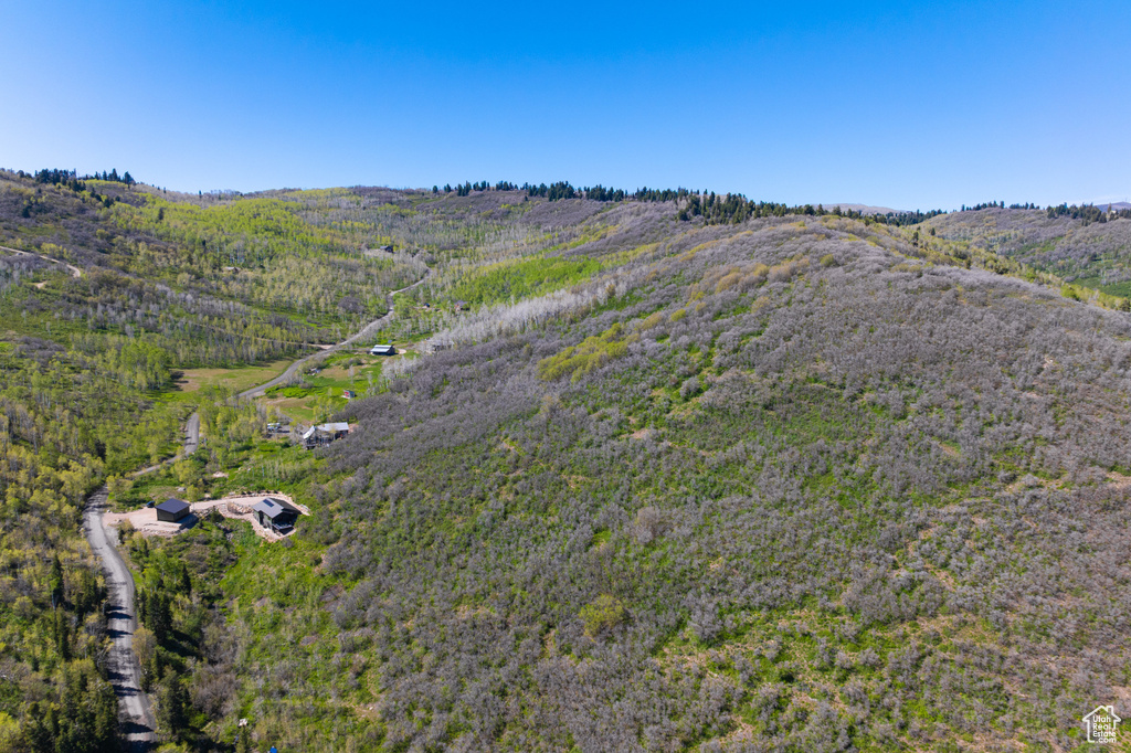 View of property location featuring a forest