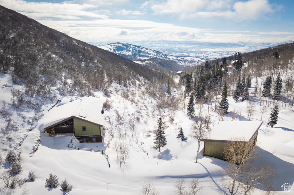 Snowy aerial view featuring a mountain view
