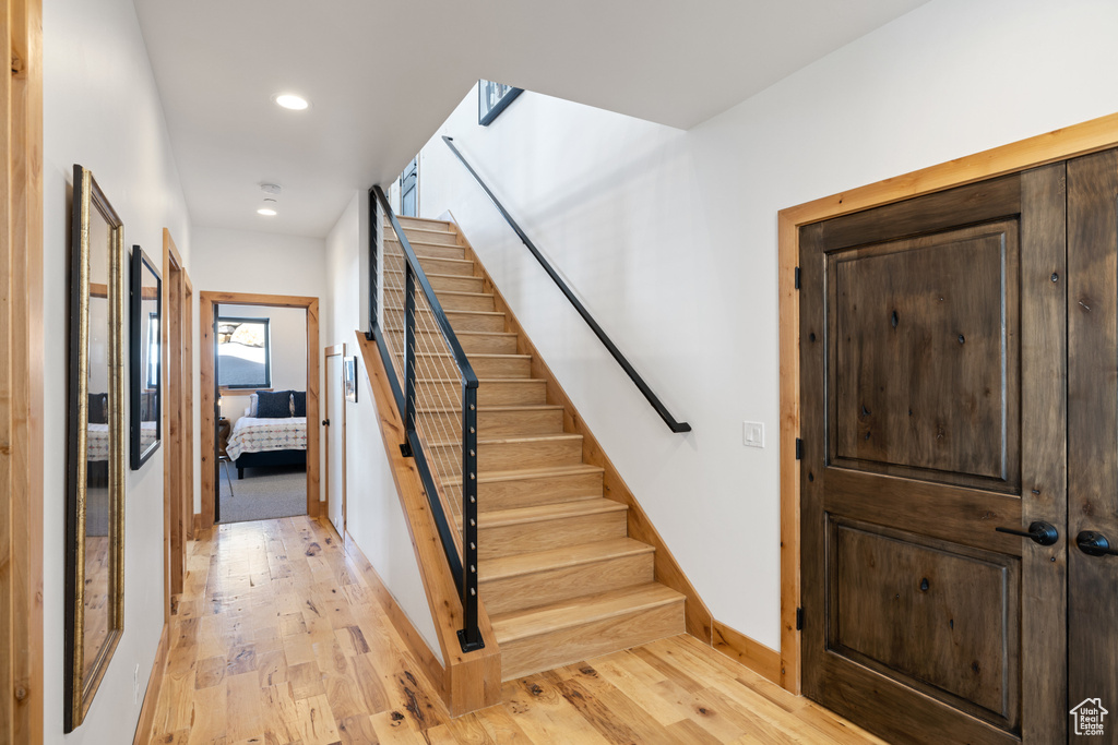 Staircase with wood-type flooring, recessed lighting, and baseboards