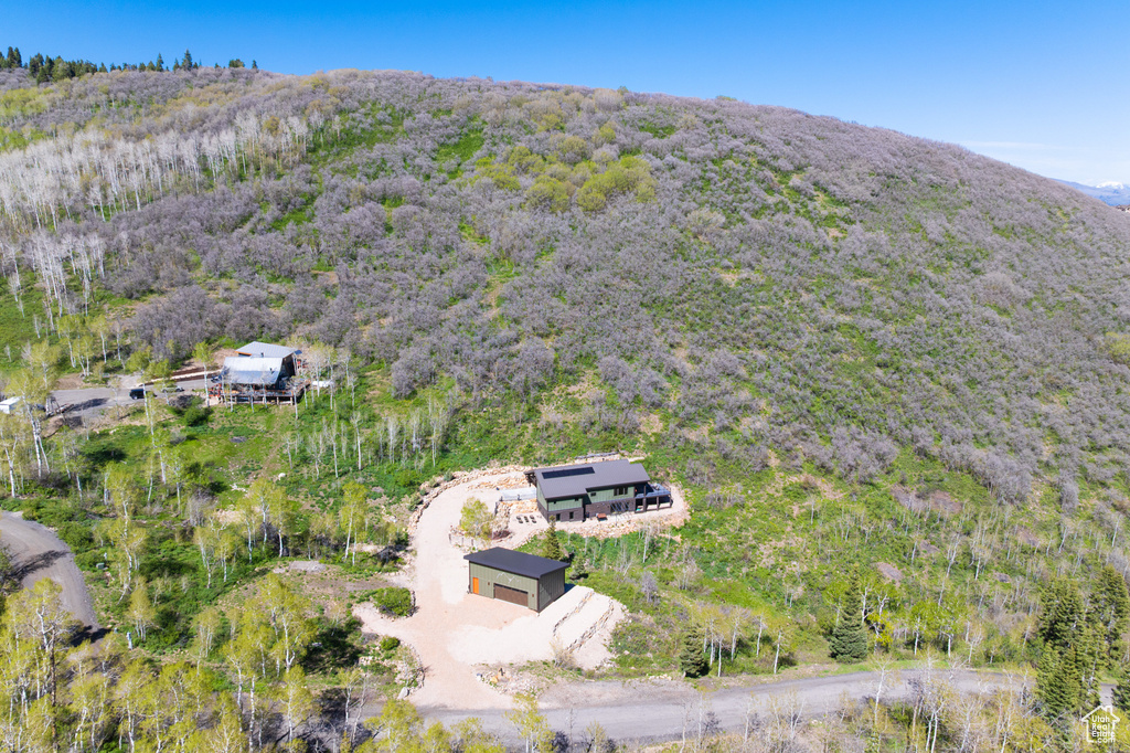 View of property location featuring a heavily wooded area and a mountainous background
