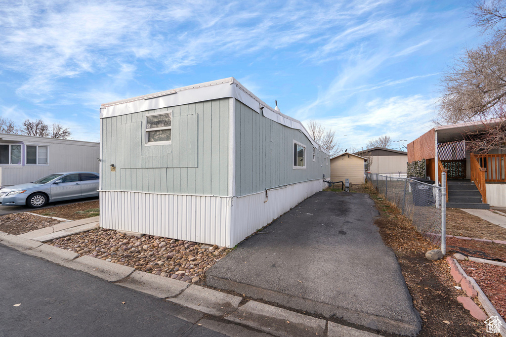 View of side of property featuring fence