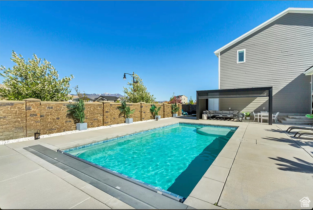 View of pool with a fenced backyard, a patio area, and an outdoor living space