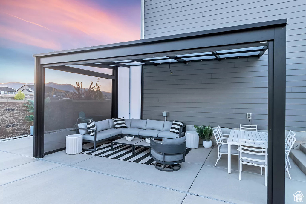 View of patio with outdoor lounge area, outdoor dining space, and a pergola