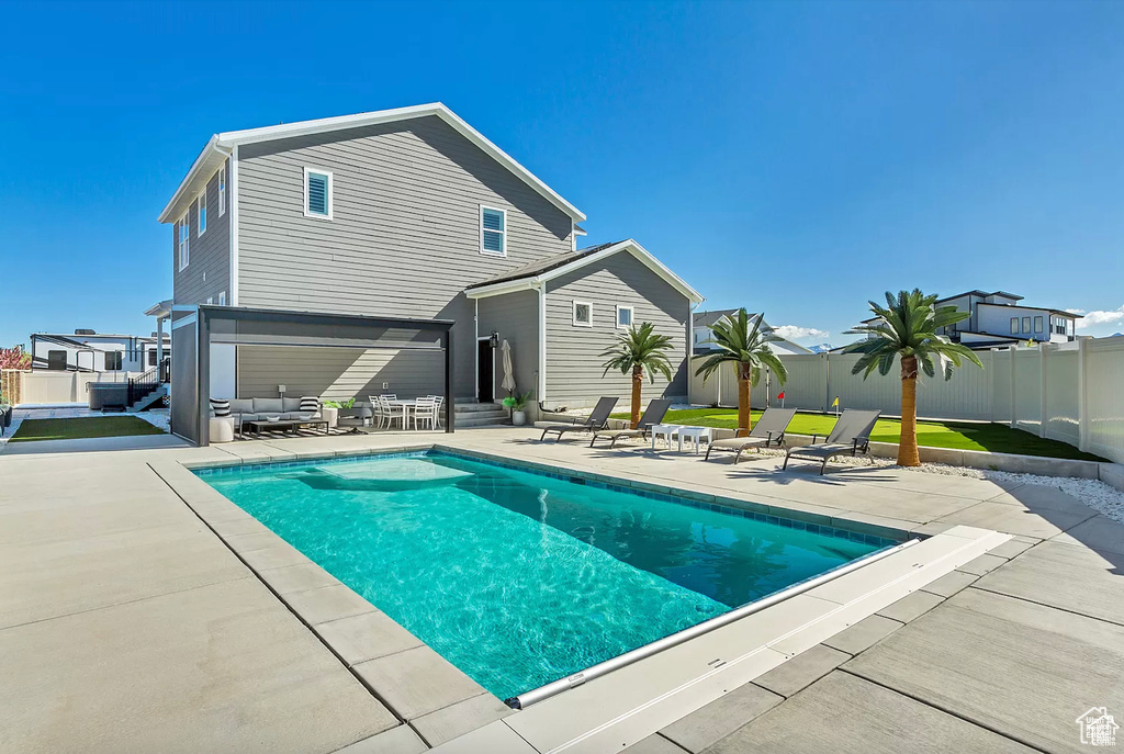 View of swimming pool with a patio area, a fenced backyard, and entry steps
