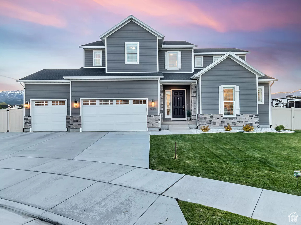 View of front facade with driveway and a garage