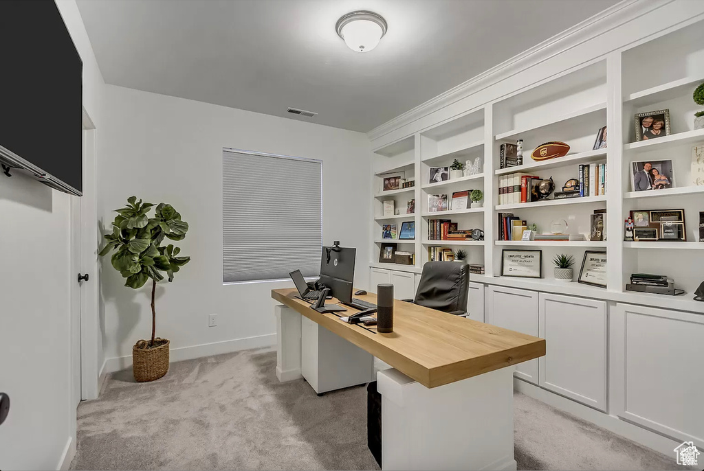 Office with light colored carpet and baseboards
