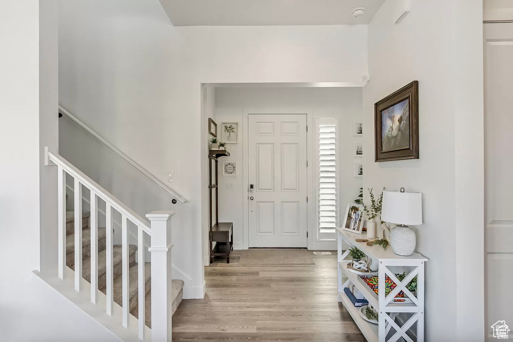Entryway featuring wood finished floors and stairs