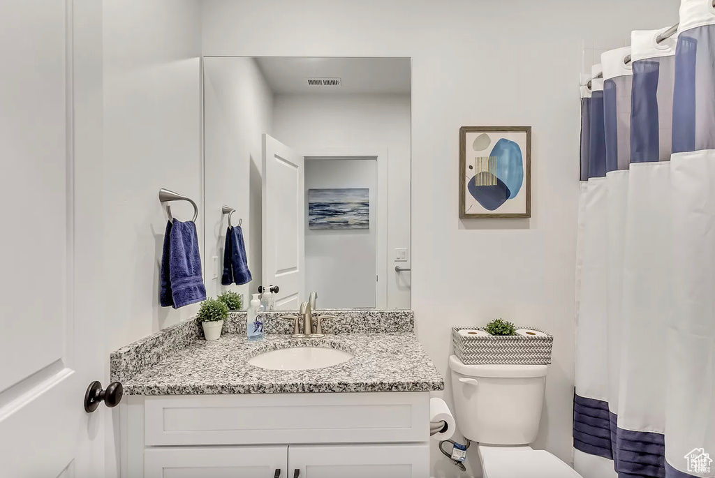 Full bathroom with vanity and toilet