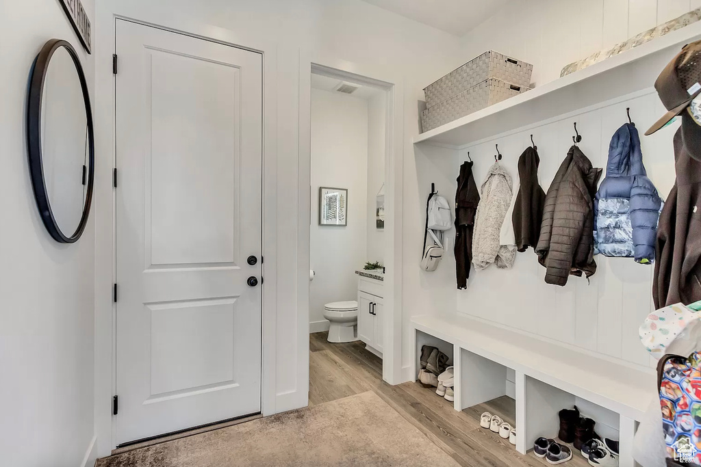 Mudroom featuring light wood-type flooring and baseboards