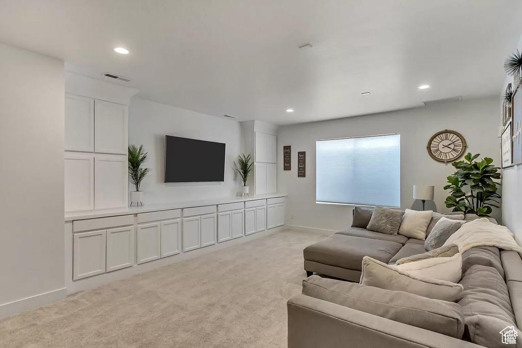 Living room featuring light colored carpet, recessed lighting, and baseboards