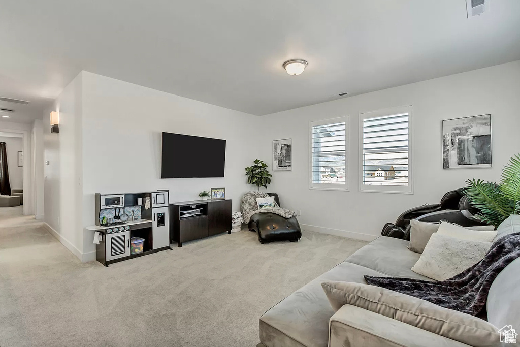 Carpeted living area with baseboards