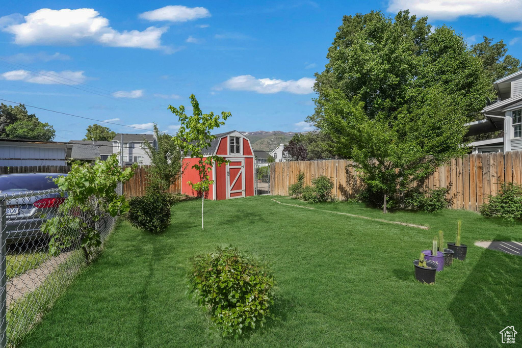 View of yard with an outbuilding and a storage unit