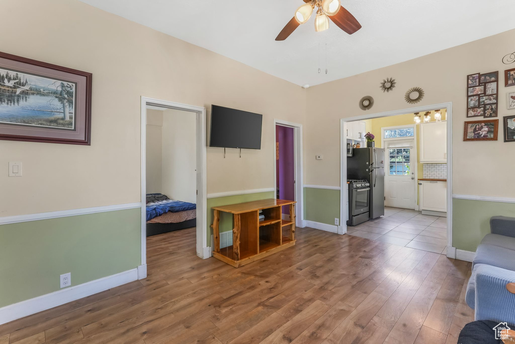 Living area featuring hardwood / wood-style flooring, ceiling fan, and baseboards