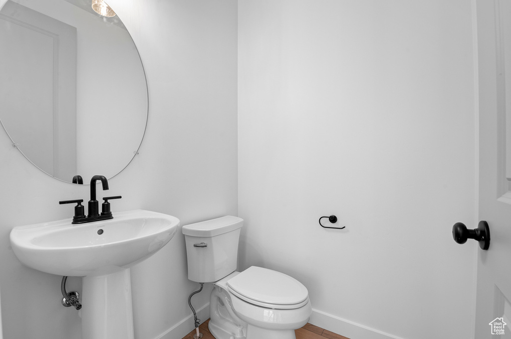 Bathroom featuring baseboards and toilet