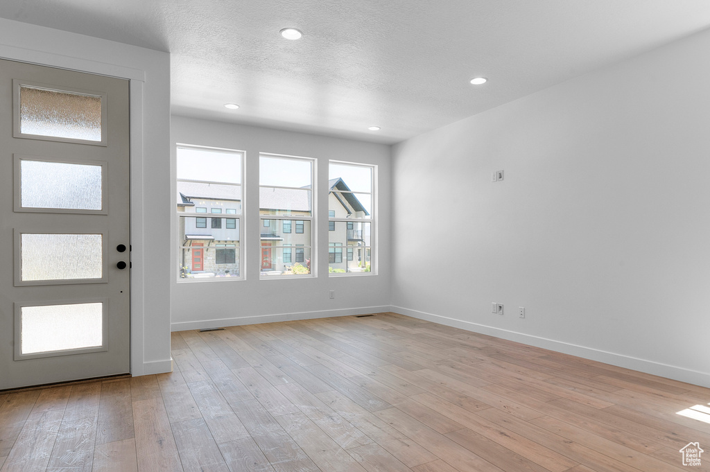 Entryway with light wood-type flooring, baseboards, and recessed lighting