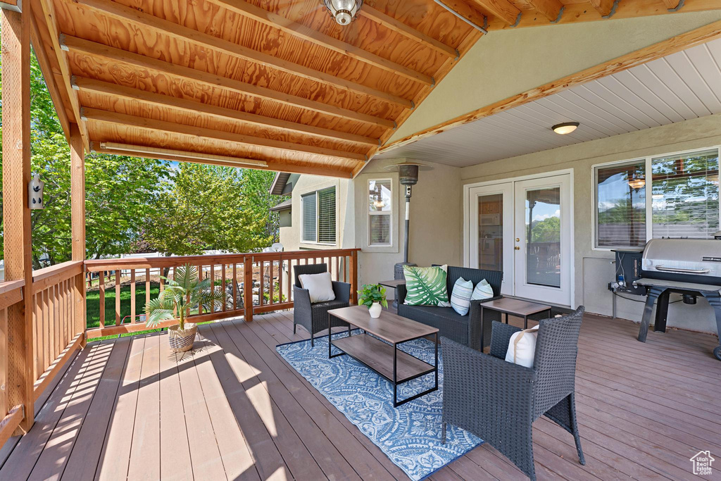 Wooden deck with french doors and an outdoor hangout area