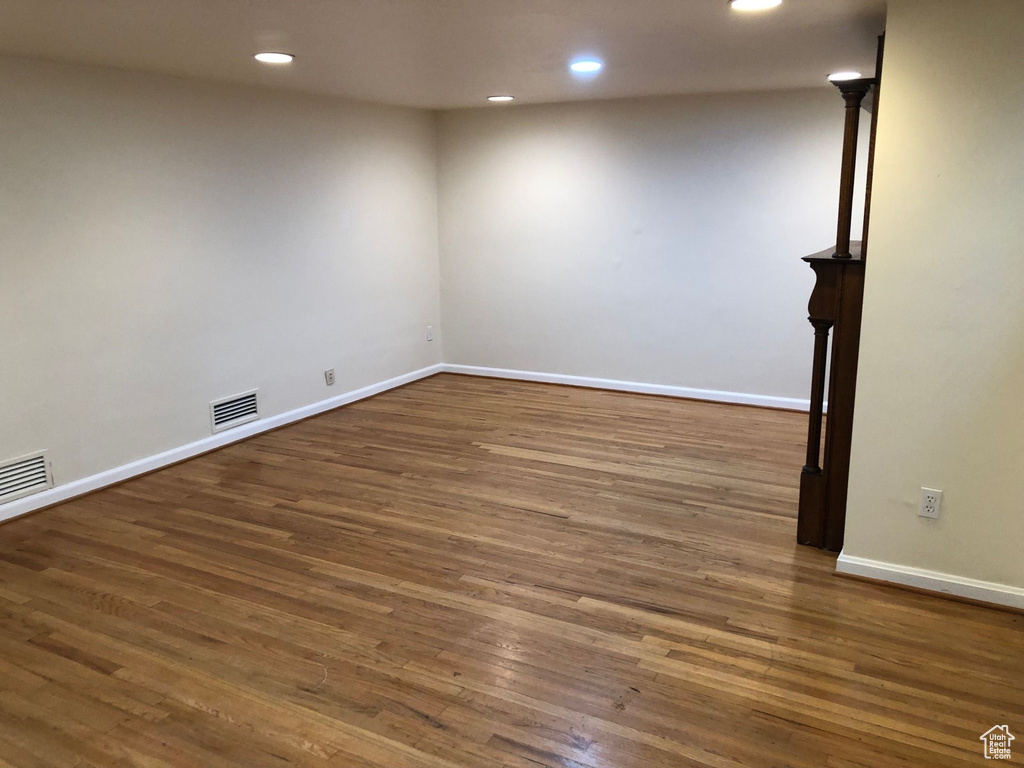 Unfurnished room featuring recessed lighting, dark wood finished floors, and baseboards